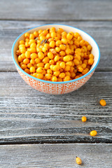 Seabuckthorn in a bowl on wooden boards