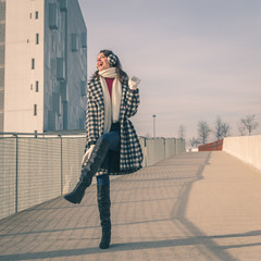 Beautiful young brunette posing in the city streets
