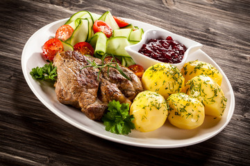 Fried steak, boiled potatoes and vegetable salad