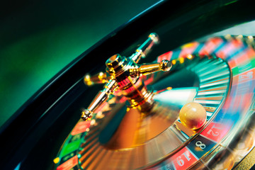 Roulette wheel in motion with a bright and colorful background