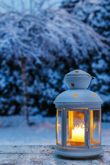 Lantern in garden, winter evening
