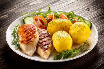 Fried chicken fillets, boiled potatoes and vegetable salad