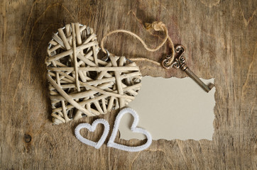 wicker heart handmade with the key and two small hearts lying on