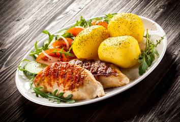 Fried chicken fillets, boiled potatoes and vegetable salad