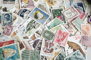 Backdrop of old postage stamps - 77798655