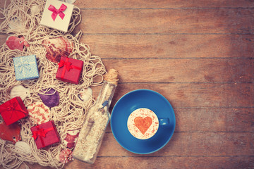 Cup, gift and net with shells and bottle