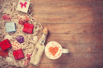 Cup, gift and net with shells and bottle