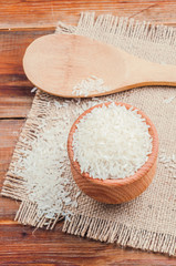 rice in a pot and spoon on burlap
