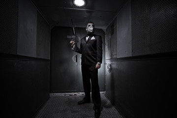 Male with the rifle and gas mask in an old elevator
