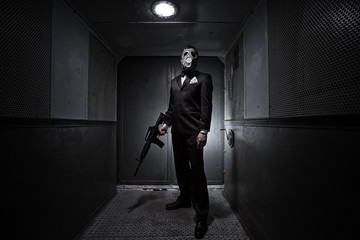 Male with the rifle and gas mask in an old elevator