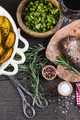 Grilled beef steak with fresh herbs and roasted potatoes