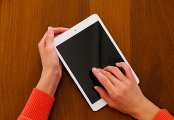 Female teen hands holding generic tablet