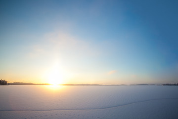 Fototapeta na wymiar Frozen lake and sunset