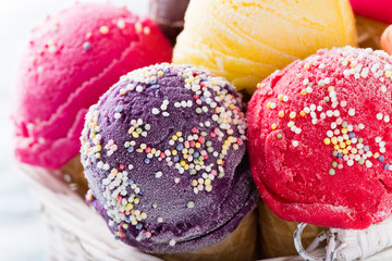 Ice cream scoops on wooden table.