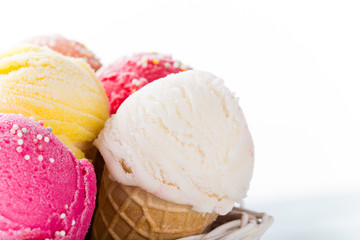 Ice cream scoops on wooden table.