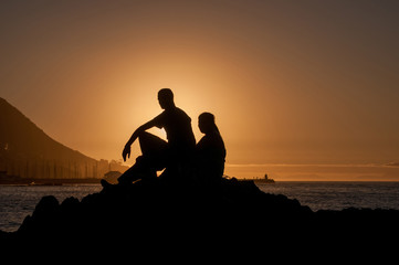 Silhouette of man and women against sunset