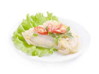Steamed fish in lime dressing on white background