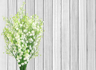 lilies of the valley flowers on color wooden planks background