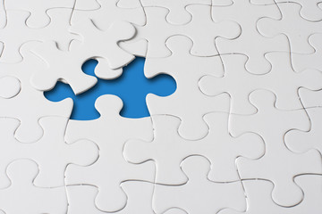Fototapeta premium Missing jigsaw puzzle piece with light glow, business concept