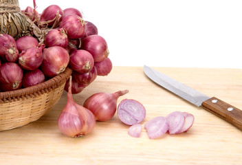 close up red onion or shallots on wooden chopping block
