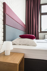 Bed with colourful headboard