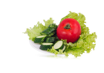 Lettuce with sliced cucumber and tomato lying on the plate