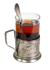 black tea in retro glass with teaspoon and glass-holder