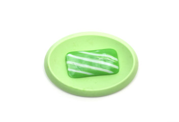 Green soap in the soap dish. Photo.