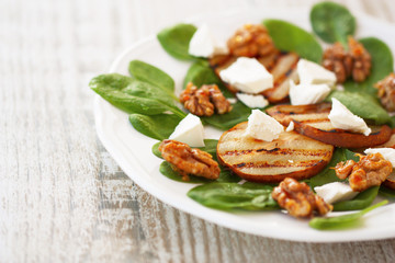 spinach salad, roasted pears, white cheese and caramelized walnu