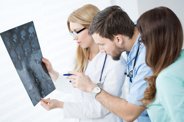 Doctors looking at brain MRI