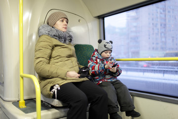 Mother with son in the bus
