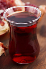 Ripe pomegranates with juice on table