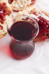 Ripe pomegranates with juice on table