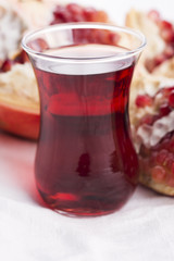 Ripe pomegranates with juice on table