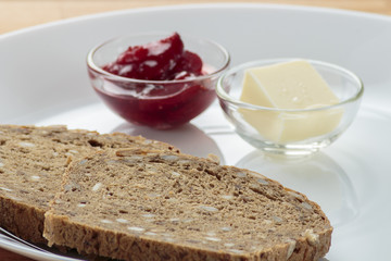 Strawberry jam, butter and rye bread..