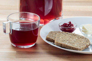 Strawberry tea, strawberry jam, butter and rye bread