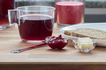 Strawberry tea, strawberry jam, butter and rye bread