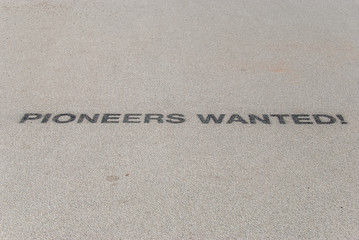 Pioneers Wanted sign on floor looking for innovators, leaders