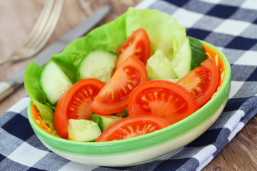 Tomato and cucumber salad in bowl, closeup
