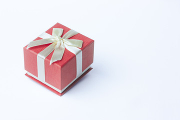 Single red gift box with ribbon on white background