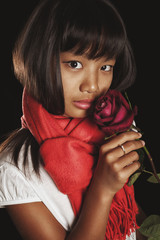 girl of Asian ethnicity in a red scarf with burgundy rose