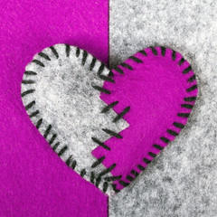 stitched broken felt heart on a on a two-color background