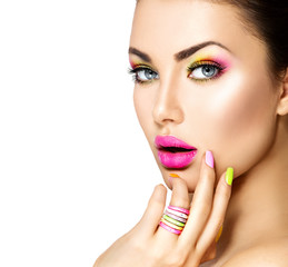 Beauty girl with colorful makeup, nail polish and accessories