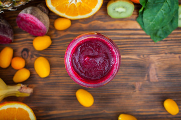 Blended purple smoothie with ingredients selective focus