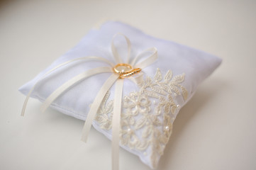 Wedding cushion with gold rings