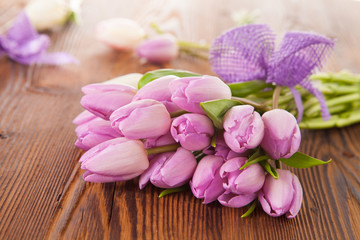 Fototapeta na wymiar Pink tulips on wooden planks