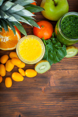 Blended green and yellow smoothie with ingredients selective foc