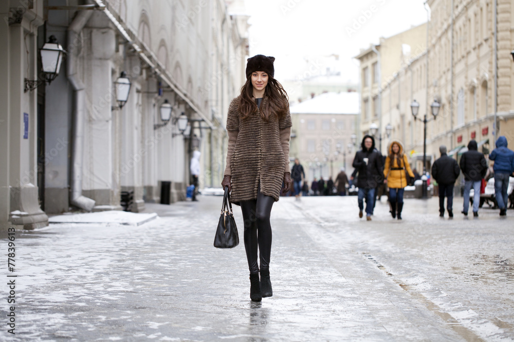 Wall mural Young beautiful woman in stylish mink coat