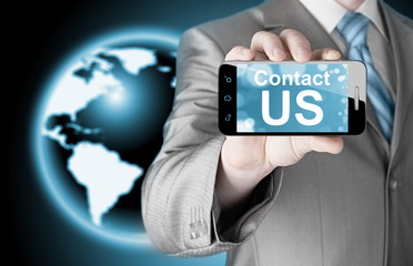 business man hand holding smartphone with the message contact us