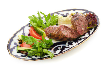 Meat on a grill with vegetables